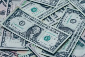 Close-up image of stacked US dollar bills representing wealth and finance.